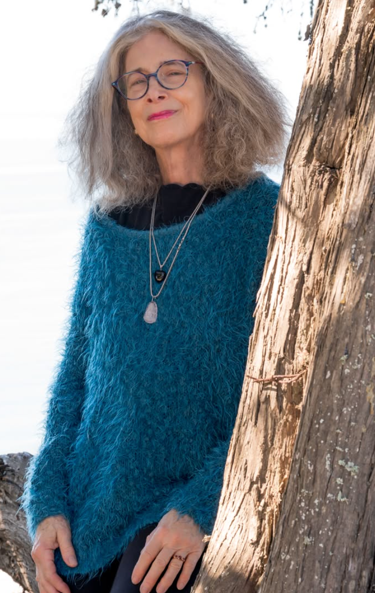 Shelley Greenbaum outdoors beside a tree